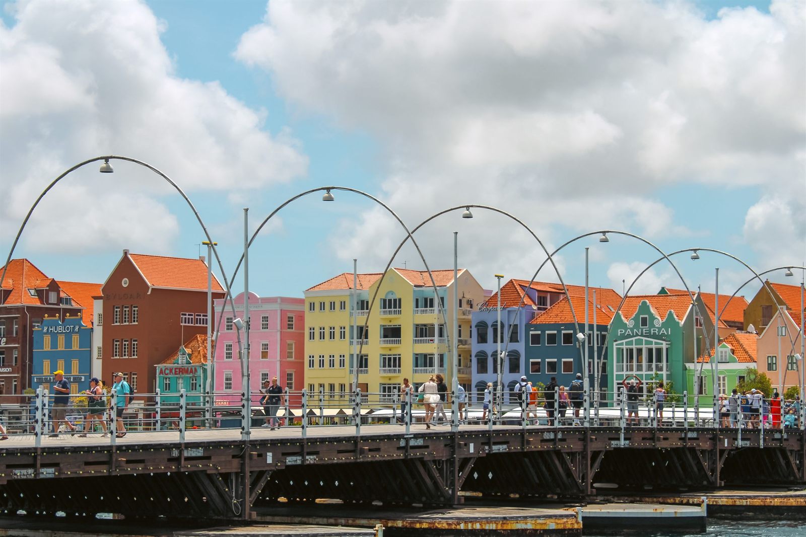Pastel Dutch colonial buildings of Willemstad, Curacao, behind the arches of the Queen Emma pontoon bridge