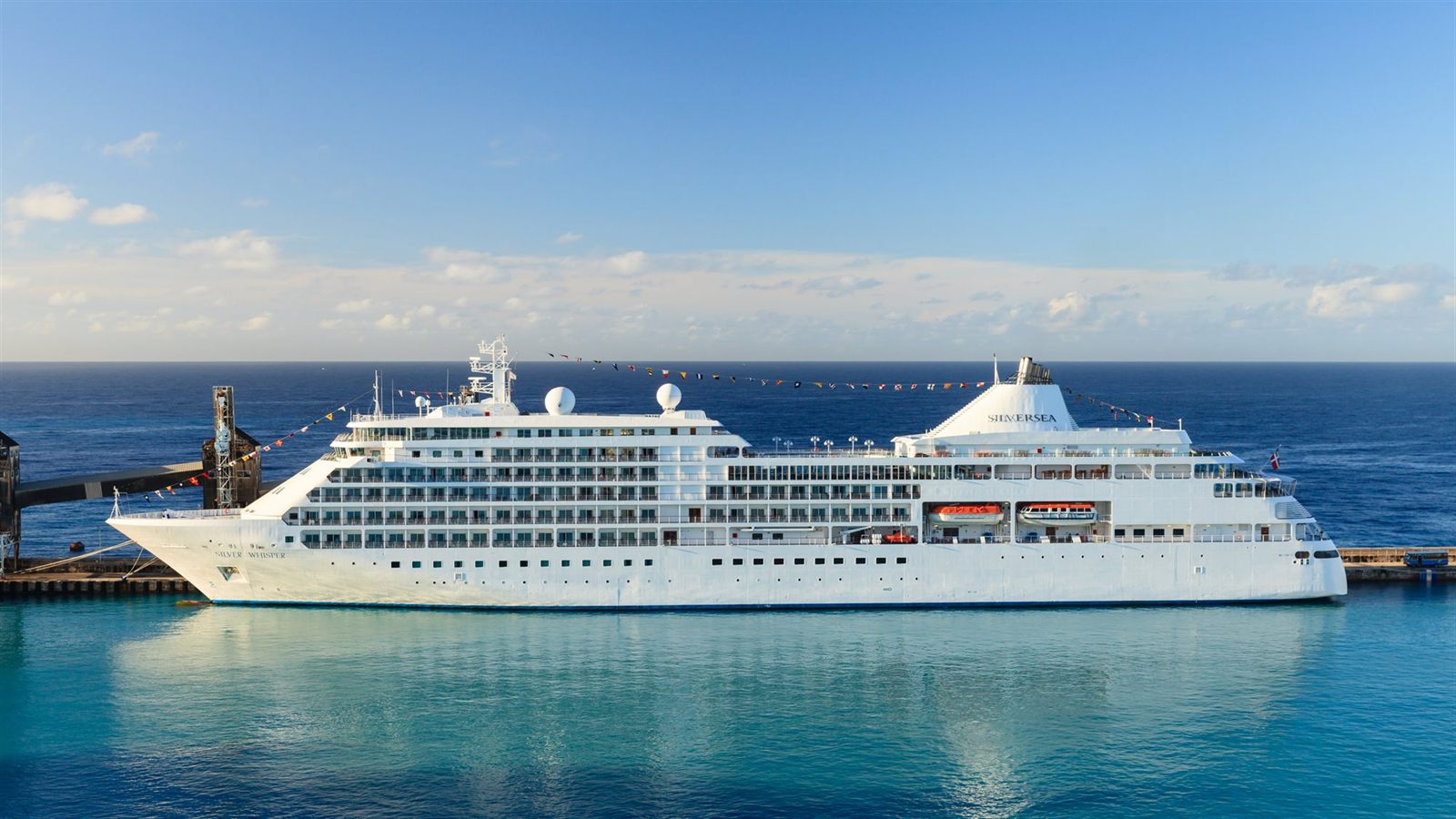 White cruise ship alongside the pier in calm turquoise water at Bridgetown, Barbados
